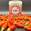 Hawaiian chili pepper salt with fresh Hawaiian chili peppers around it 